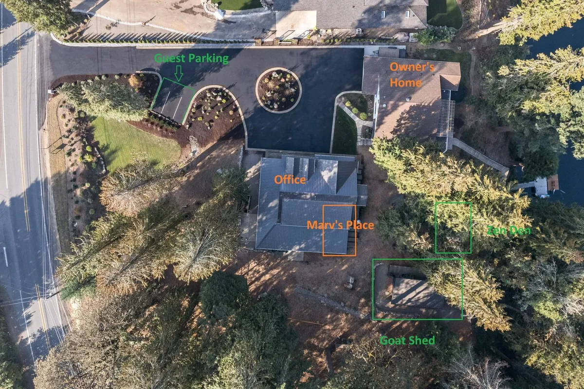 This image captures a wide view of the retreat’s grounds, including the guest parking area, the small office building, owner’s home, Marv’s Place, and a goat shed, all nestled among trees. The layout clearly defines individual residences and shared spaces.